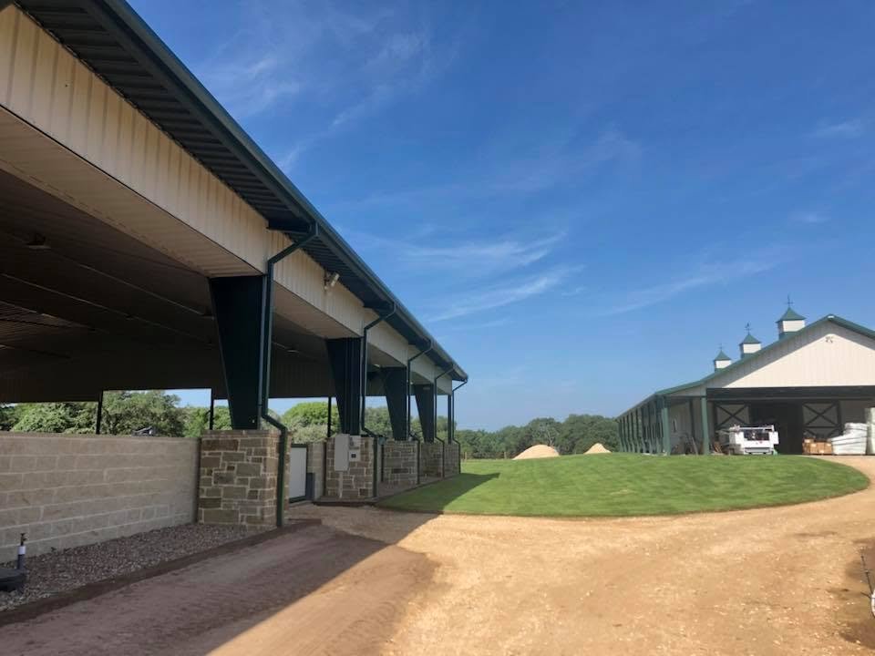 Finished grass beside the covered arena and barn