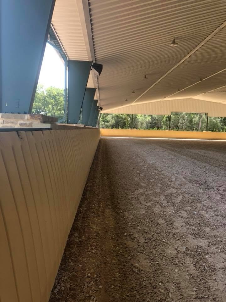 Inside the covered arena along the rail