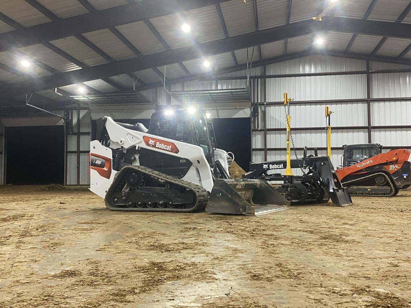 Track loaders parked inside an arena building