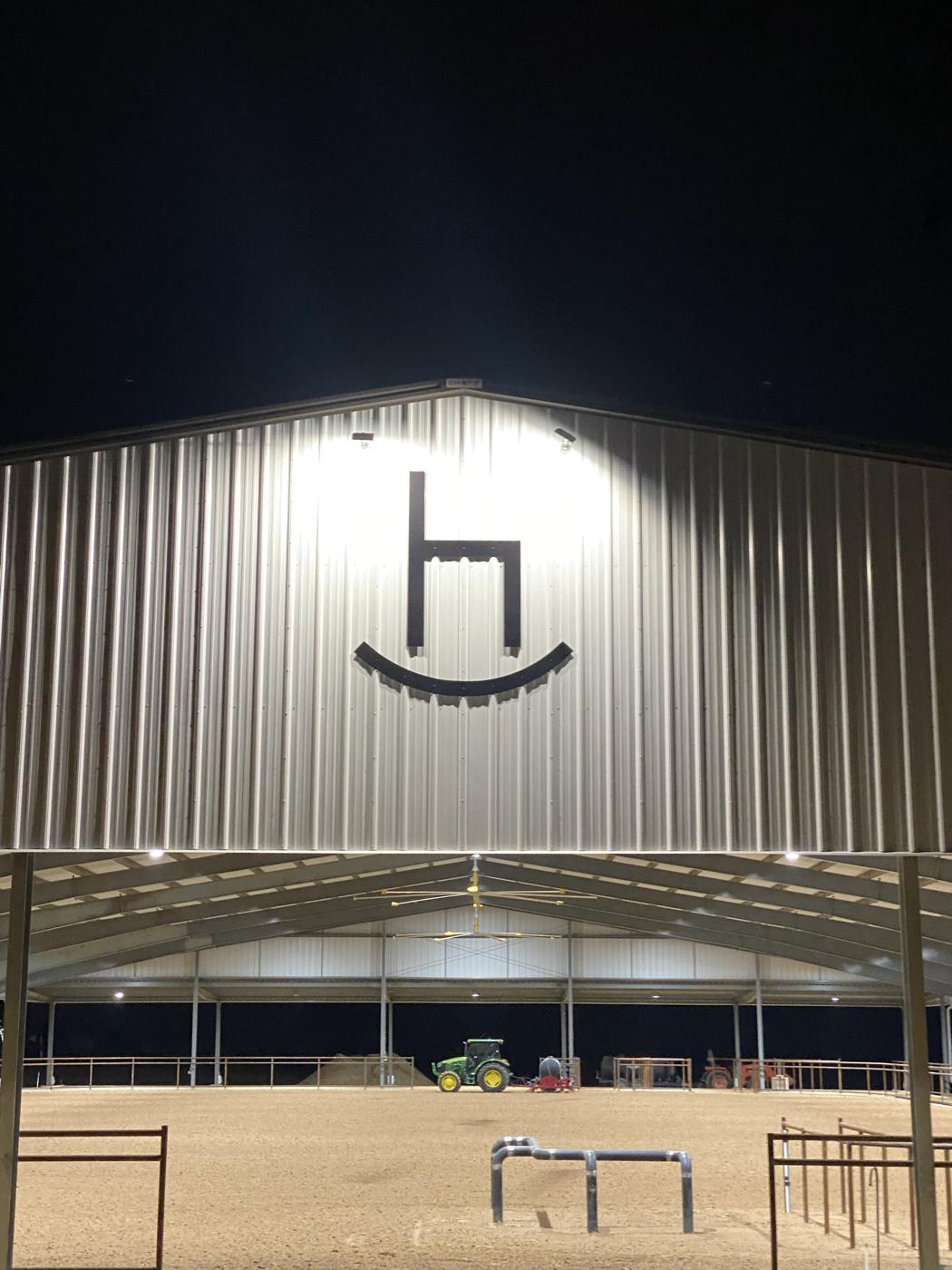 Exterior of a finished covered arena at night