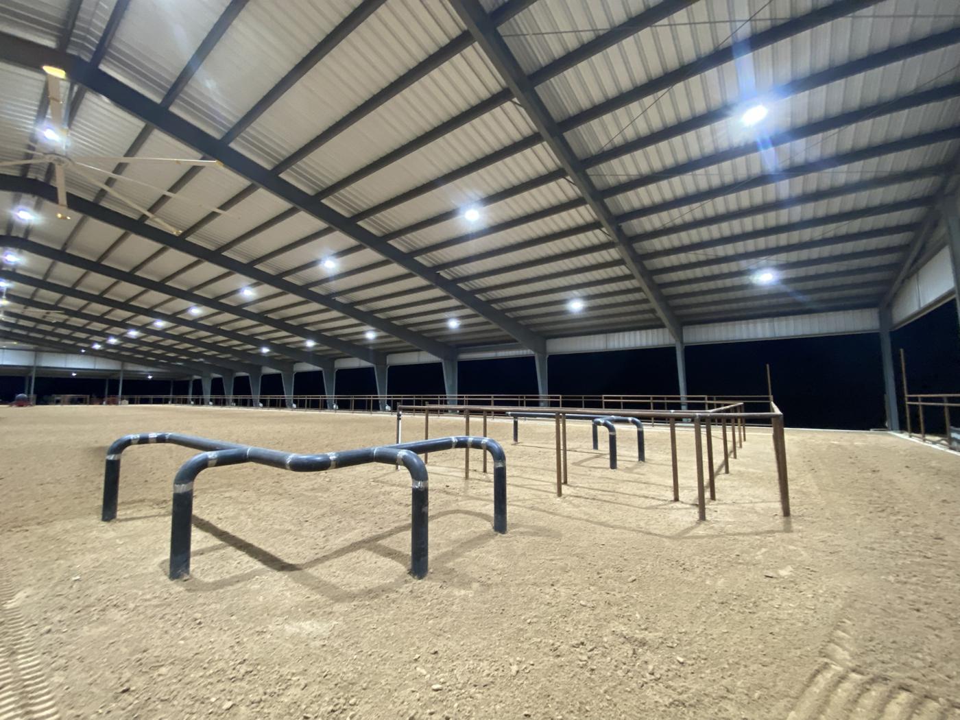 Covered arena with finished footing and pipe obstacles